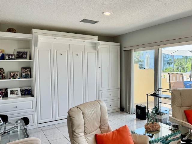 100 Bluff View Dr Unit 105C, Belleair Bluffs, FL 33770 - sitting room with a textured ceiling and light tile patterned floors