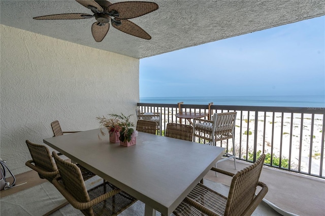3200 Gulf Blvd Unit 202, St Pete Beach, FL 33706 - balcony with a ceiling fan, view of water and beach, and outdoor dining area