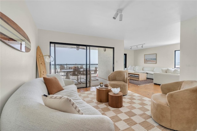 3200 Gulf Blvd Unit 202, St Pete Beach, FL 33706 - living area featuring light wood-type flooring, track lighting, and a ceiling fan
