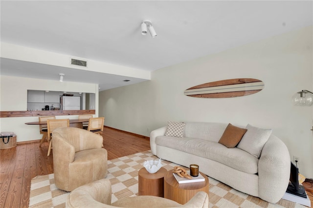 3200 Gulf Blvd Unit 202, St Pete Beach, FL 33706 - living area with light wood-type flooring and baseboards