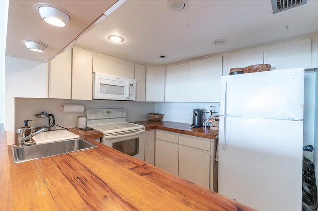 3200 Gulf Blvd Unit 202, St Pete Beach, FL 33706 - kitchen with white appliances, a sink, butcher block countertops, white cabinets, and recessed lighting