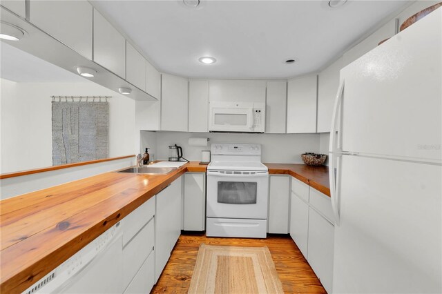 3200 Gulf Blvd Unit 202, St Pete Beach, FL 33706 - kitchen with white appliances, a sink, butcher block countertops, light wood-style flooring, and recessed lighting