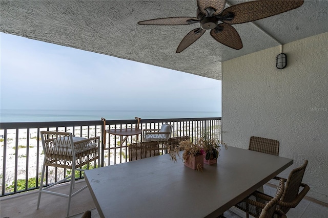 3200 Gulf Blvd Unit 202, St Pete Beach, FL 33706 - balcony with ceiling fan, a water view, and outdoor dining space