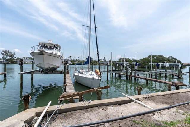 3200 Gulf Blvd Unit 202, St Pete Beach, FL 33706 - dock area featuring boat lift and a water view