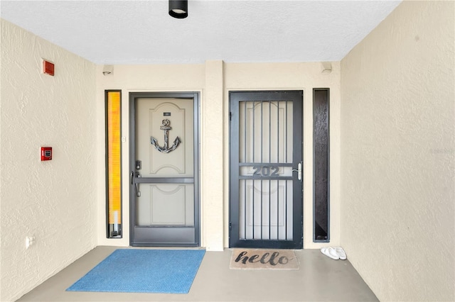 3200 Gulf Blvd Unit 202, St Pete Beach, FL 33706 - doorway to property with stucco siding