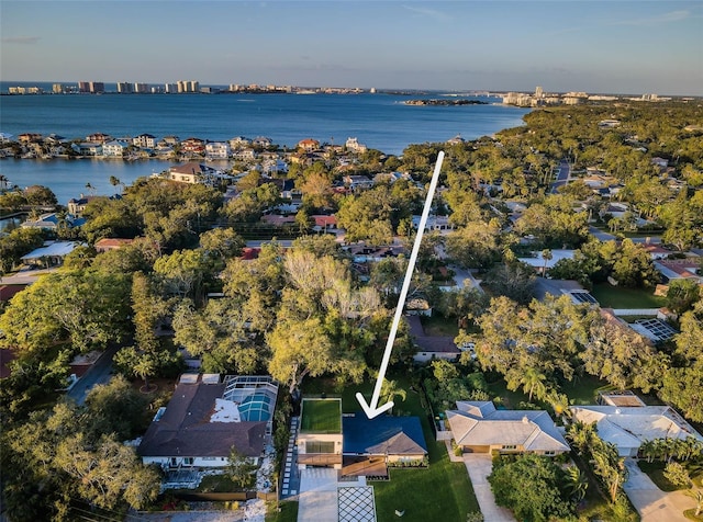 aerial overview of property's location with a nearby body of water and nearby suburban area
