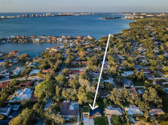 aerial overview of property's location with a large body of water and nearby suburban area