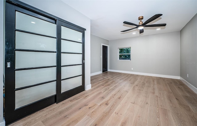 spare room featuring light wood-style flooring, ceiling fan, baseboards, and recessed lighting