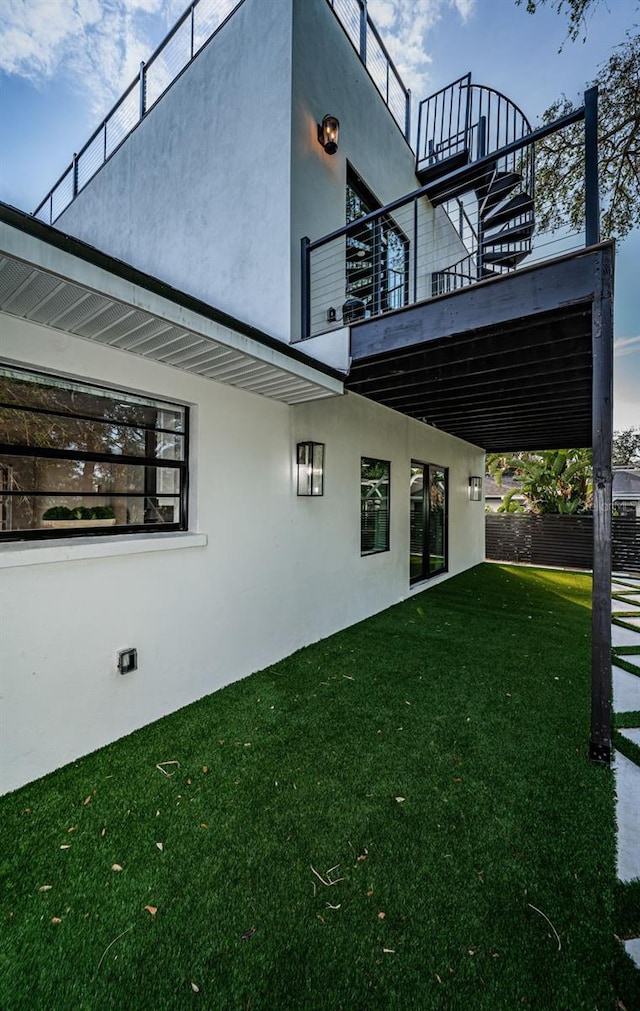view of property exterior featuring stucco siding and a balcony