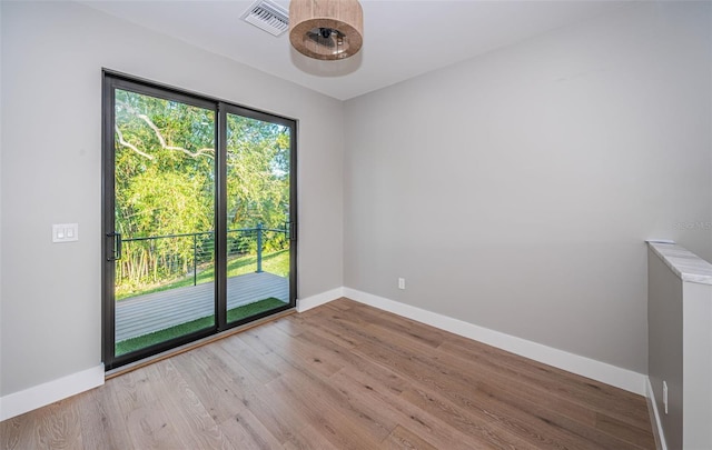 unfurnished room featuring baseboards and wood finished floors