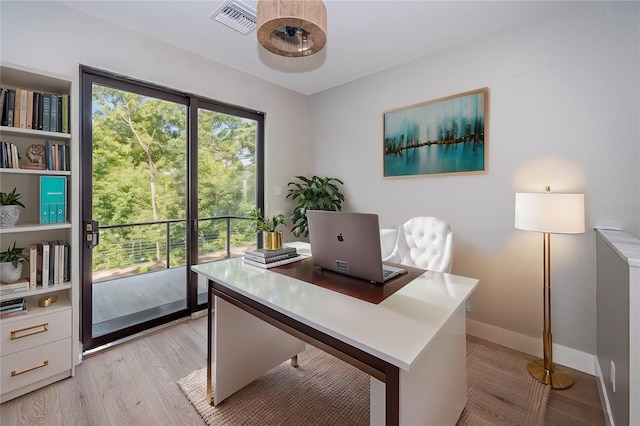 home office featuring light wood-style floors and baseboards