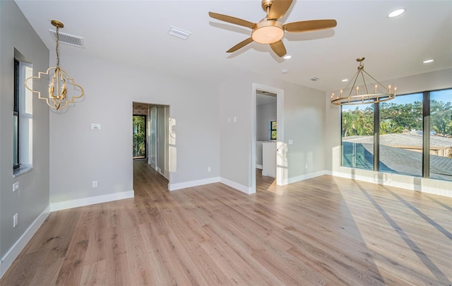 unfurnished living room featuring a chandelier, light wood-type flooring, recessed lighting, baseboards, and ceiling fan