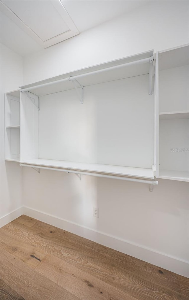 walk in closet featuring wood finished floors