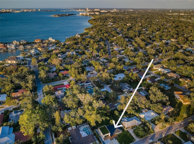 aerial view of property and surrounding area with a nearby body of water and nearby suburban area