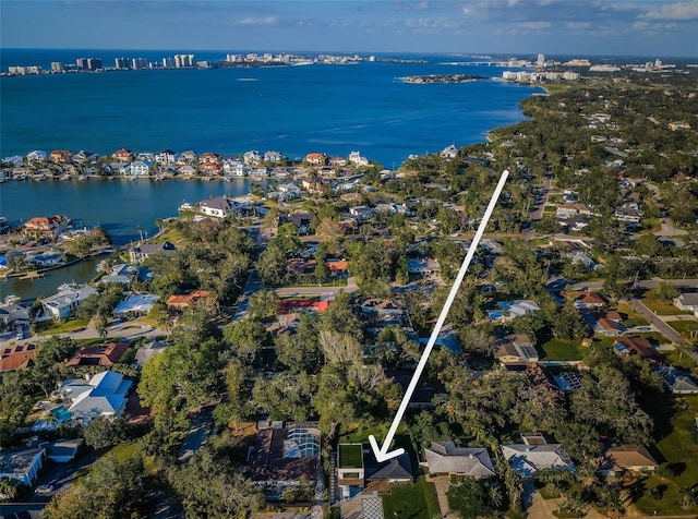 aerial view of property's location with a nearby body of water and nearby suburban area