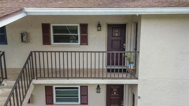 9821 113th St Unit 201, Seminole, FL 33772 - entrance to property featuring roof with shingles and stucco siding