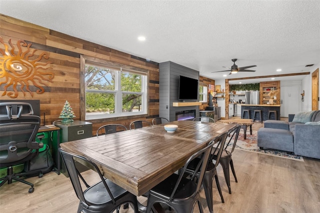 9821 113th St Unit 201, Seminole, FL 33772 - dining space featuring a textured ceiling, wooden walls, light wood-style flooring, ceiling fan, and recessed lighting