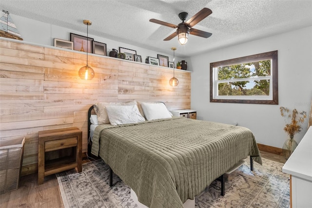 9821 113th St Unit 201, Seminole, FL 33772 - bedroom featuring a textured ceiling, wood finished floors, and a ceiling fan