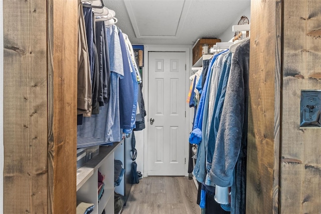 9821 113th St Unit 201, Seminole, FL 33772 - walk in closet featuring wood finished floors and attic access
