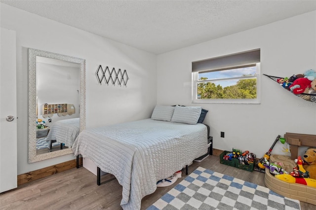 9821 113th St Unit 201, Seminole, FL 33772 - bedroom featuring wood finished floors and a textured ceiling