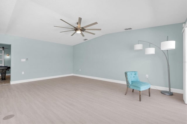 unfurnished room with a ceiling fan, light wood-style floors, lofted ceiling, and baseboards