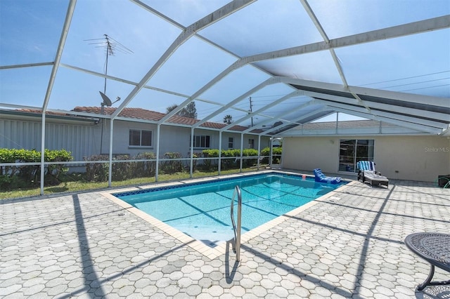 swimming pool featuring a patio area and glass enclosure