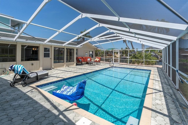 outdoor pool featuring a patio, glass enclosure, and outdoor lounge area