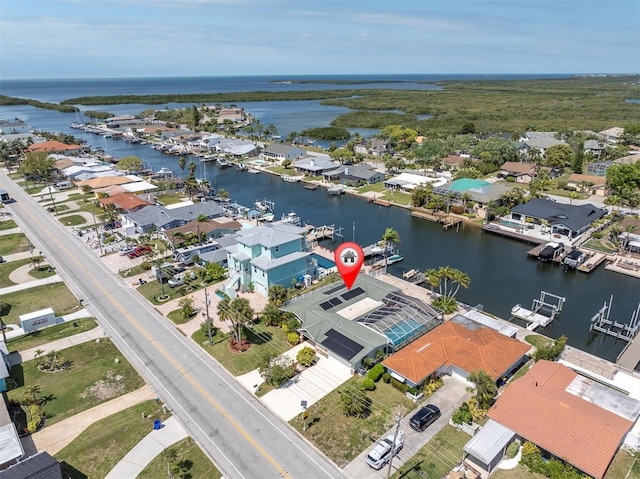aerial view of residential area featuring a large body of water