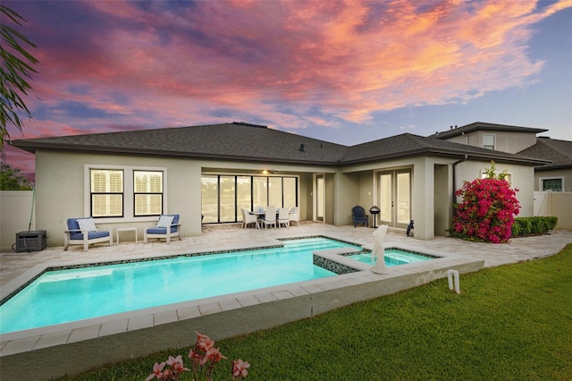 21642 Emory Oak Pl, Land O Lakes, FL 34637 - rear view of property featuring french doors, stucco siding, a patio area, roof with shingles, and a pool with connected hot tub