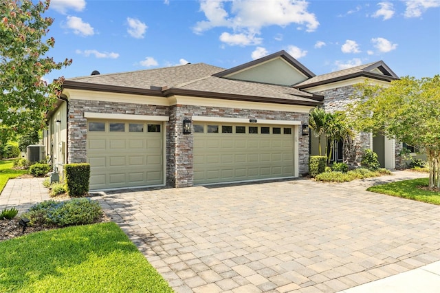 21642 Emory Oak Pl, Land O Lakes, FL 34637 - view of front of property featuring an attached garage, decorative driveway, and stone siding