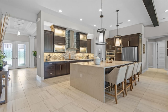 21642 Emory Oak Pl, Land O Lakes, FL 34637 - kitchen with appliances with stainless steel finishes, wall chimney range hood, decorative backsplash, beam ceiling, and light countertops