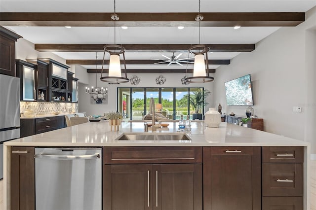 21642 Emory Oak Pl, Land O Lakes, FL 34637 - kitchen with stainless steel appliances, a sink, a chandelier, backsplash, and dark brown cabinetry