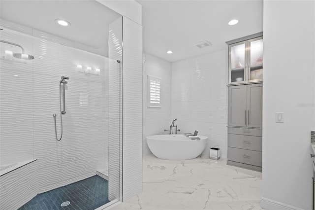 21642 Emory Oak Pl, Land O Lakes, FL 34637 - full bathroom with a freestanding tub, a stall shower, marble finish flooring, recessed lighting, and vanity