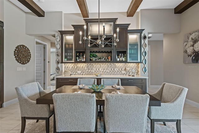 21642 Emory Oak Pl, Land O Lakes, FL 34637 - dining room featuring beam ceiling, a chandelier, light tile patterned floors, and baseboards