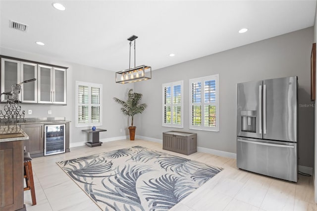 21642 Emory Oak Pl, Land O Lakes, FL 34637 - kitchen featuring stainless steel fridge, wine cooler, glass insert cabinets, decorative light fixtures, and recessed lighting