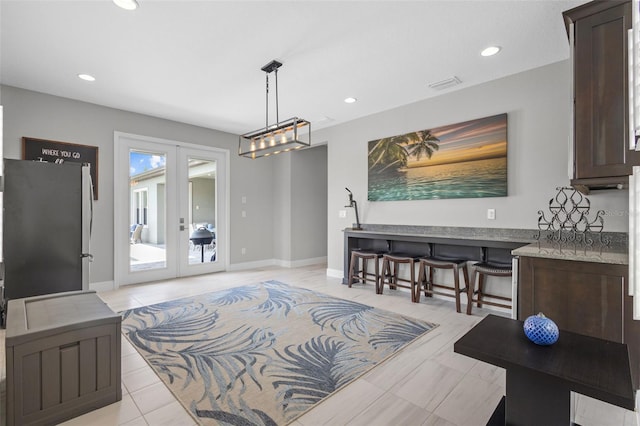 21642 Emory Oak Pl, Land O Lakes, FL 34637 - dining space featuring french doors, recessed lighting, baseboards, and light tile patterned floors