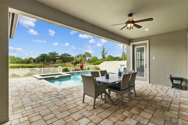 21642 Emory Oak Pl, Land O Lakes, FL 34637 - fenced backyard featuring a patio, ceiling fan, a water view, outdoor dining area, and a pool with connected hot tub