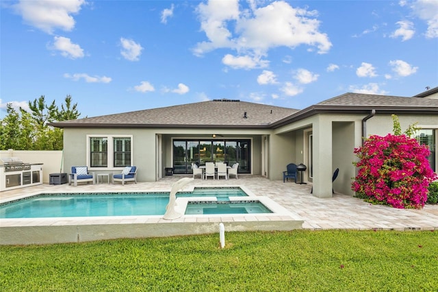 21642 Emory Oak Pl, Land O Lakes, FL 34637 - back of property with stucco siding, a patio area, a pool with connected hot tub, and roof with shingles