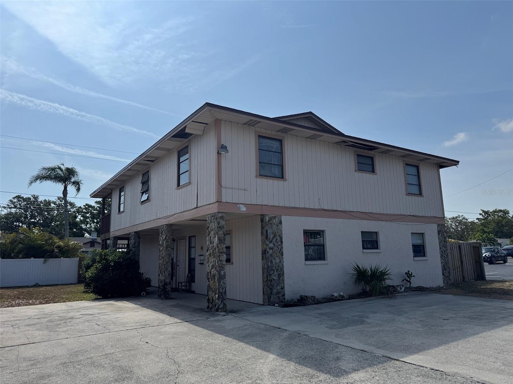 3033 16th St N, Saint Petersburg, FL 33704 - view of property exterior with fence and covered porch