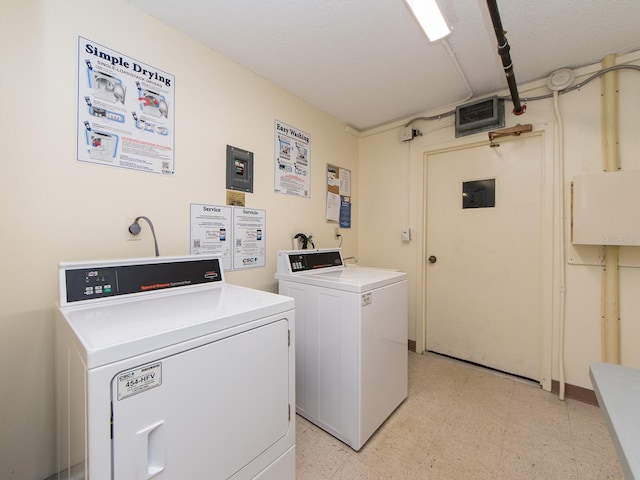 community laundry featuring washing machine and clothes dryer and light floors