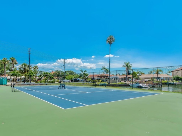 view of tennis court featuring fence