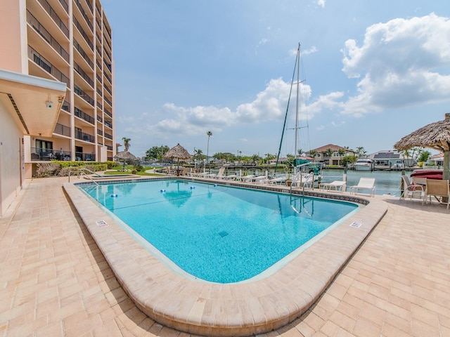 community pool featuring a patio and a water view