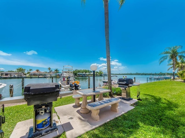 view of patio featuring a water view and grilling area