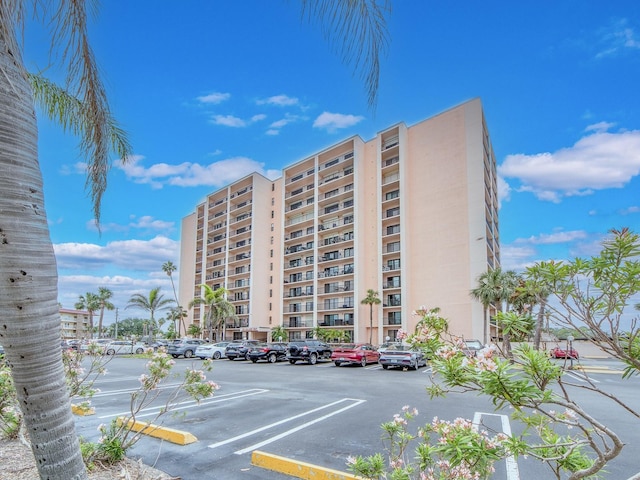 view of apartment building / complex featuring uncovered parking