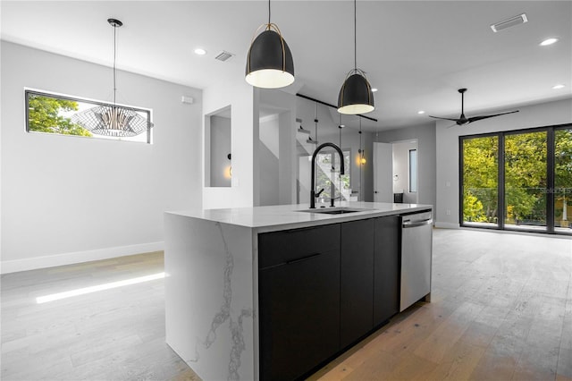 607 W Euclid Ave Unit 3, Tampa, FL 33602 - kitchen featuring dishwasher, a sink, modern cabinets, baseboards, and light wood-style floors