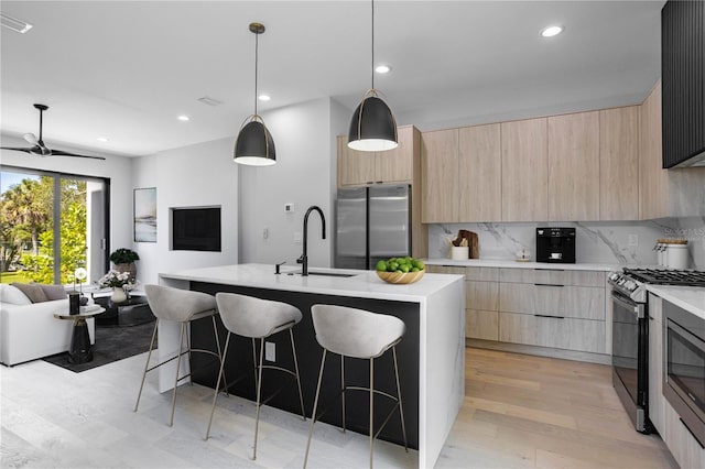 607 W Euclid Ave Unit 3, Tampa, FL 33602 - kitchen with light brown cabinets, modern cabinets, stainless steel appliances, open floor plan, and recessed lighting
