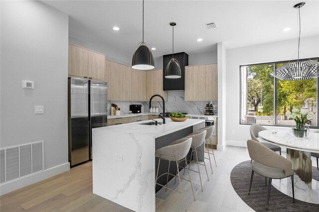 607 W Euclid Ave Unit 3, Tampa, FL 33602 - kitchen featuring freestanding refrigerator, modern cabinets, light brown cabinets, a sink, and recessed lighting