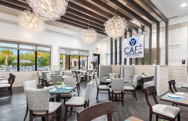 dining space with a chandelier and a towering ceiling