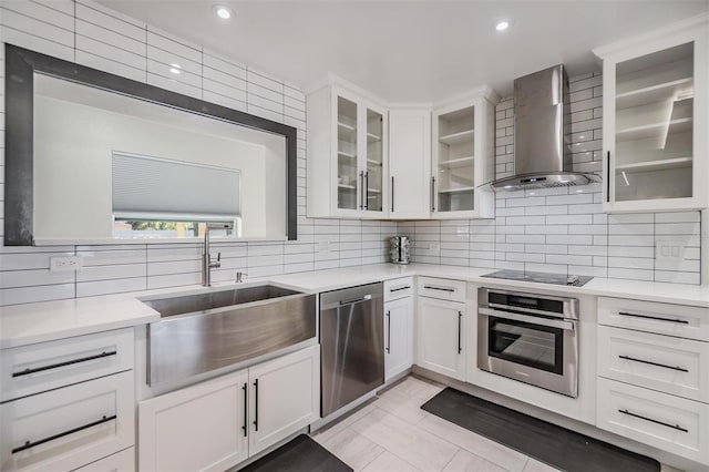 5744 150th Ave N, Clearwater, FL 33760 - kitchen with stainless steel appliances, wall chimney exhaust hood, light countertops, a sink, and decorative backsplash