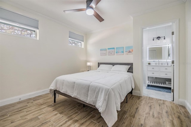 5744 150th Ave N, Clearwater, FL 33760 - bedroom featuring ornamental molding, wood finished floors, baseboards, ensuite bathroom, and a sink